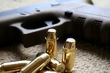 A Glock hand gun and bullets.