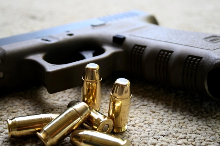 A Glock hand gun and bullets.