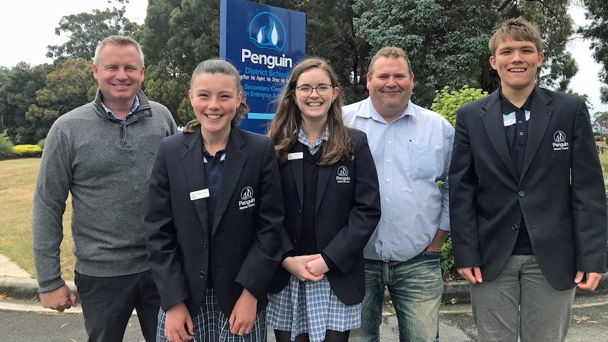 Jeremy Rockliff and Adam Brooks pose with students from Penguin District School.