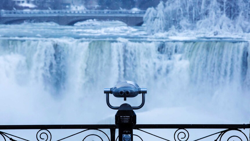 A pair of binoculars looks over ice forming at the base of Niagara Falls.