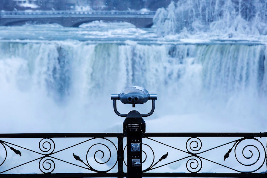 A pair of binoculars looks over ice forming at the base of Niagara Falls.