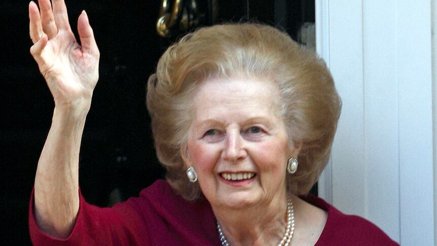 Margaret Thatcher waves from her front doorstep after returning from hospital.