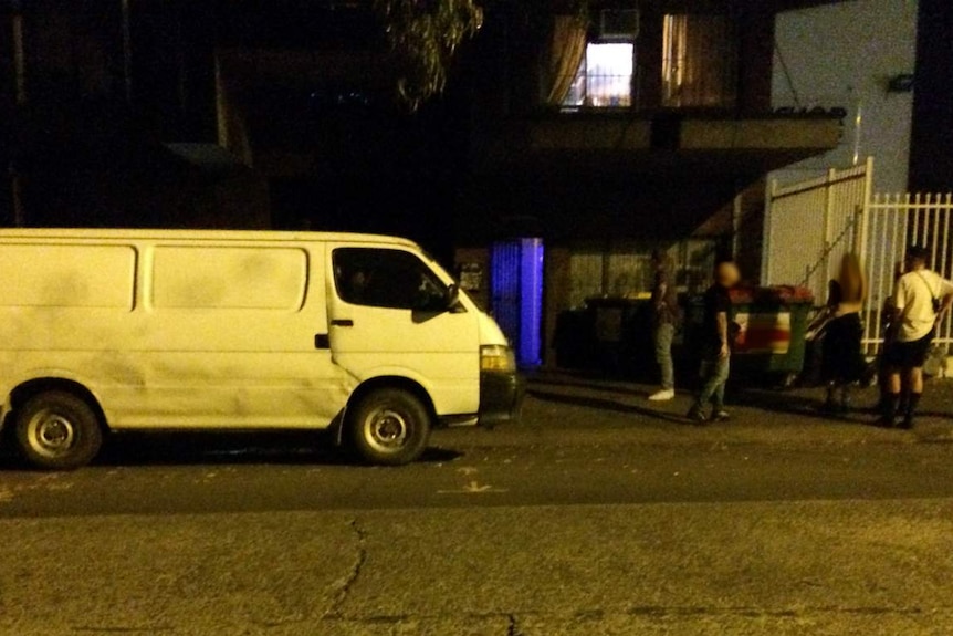 A van and the entrance to a warehouse.