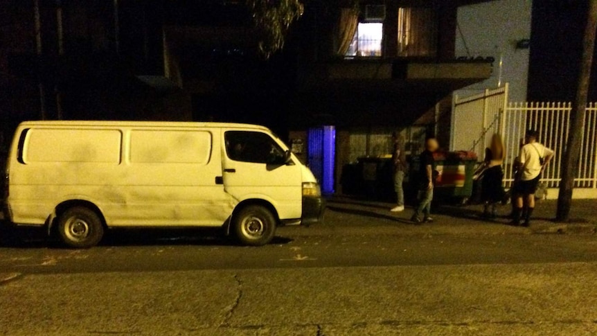 A van and the entrance to a warehouse.