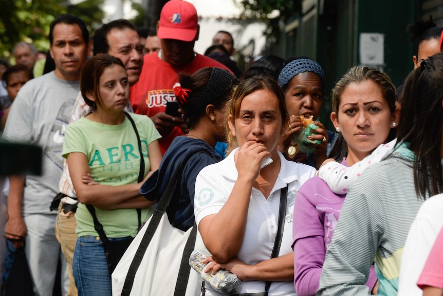 People queued up outside a supermarket.