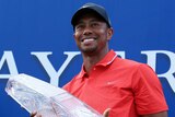 Tiger Woods holds the winner's trophy for the 2012 Players Championship.