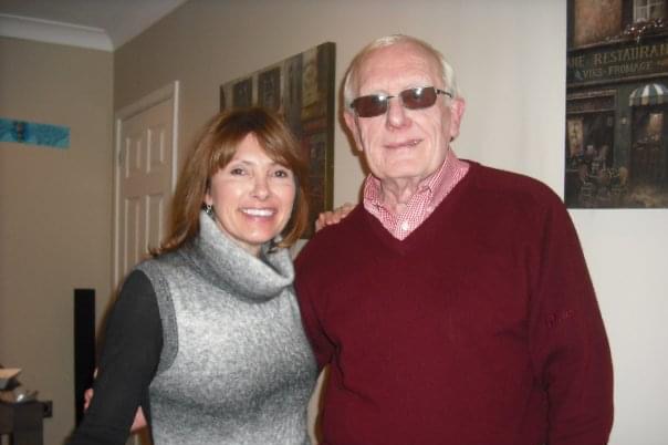 Paula standing with her father with her arm around him