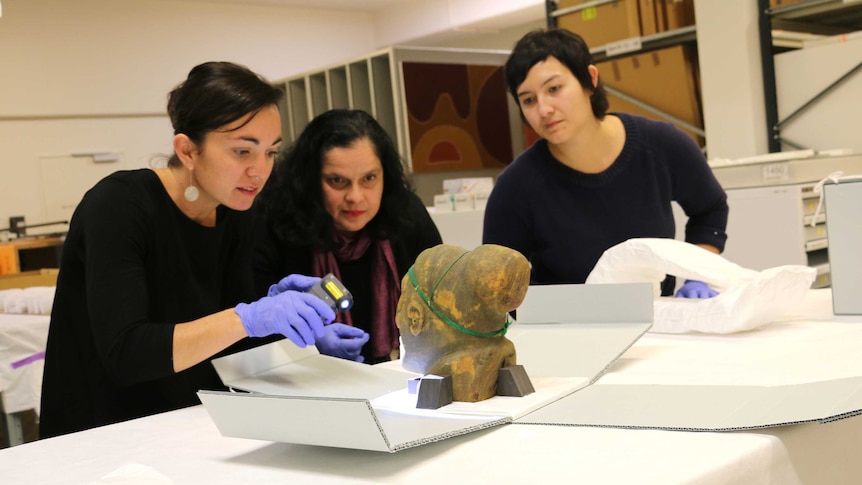 Associate Registrar Kelly Rowe, Bendt Museum director Vanessa Russ and assistant Sarah Ridhuan examine the collection.