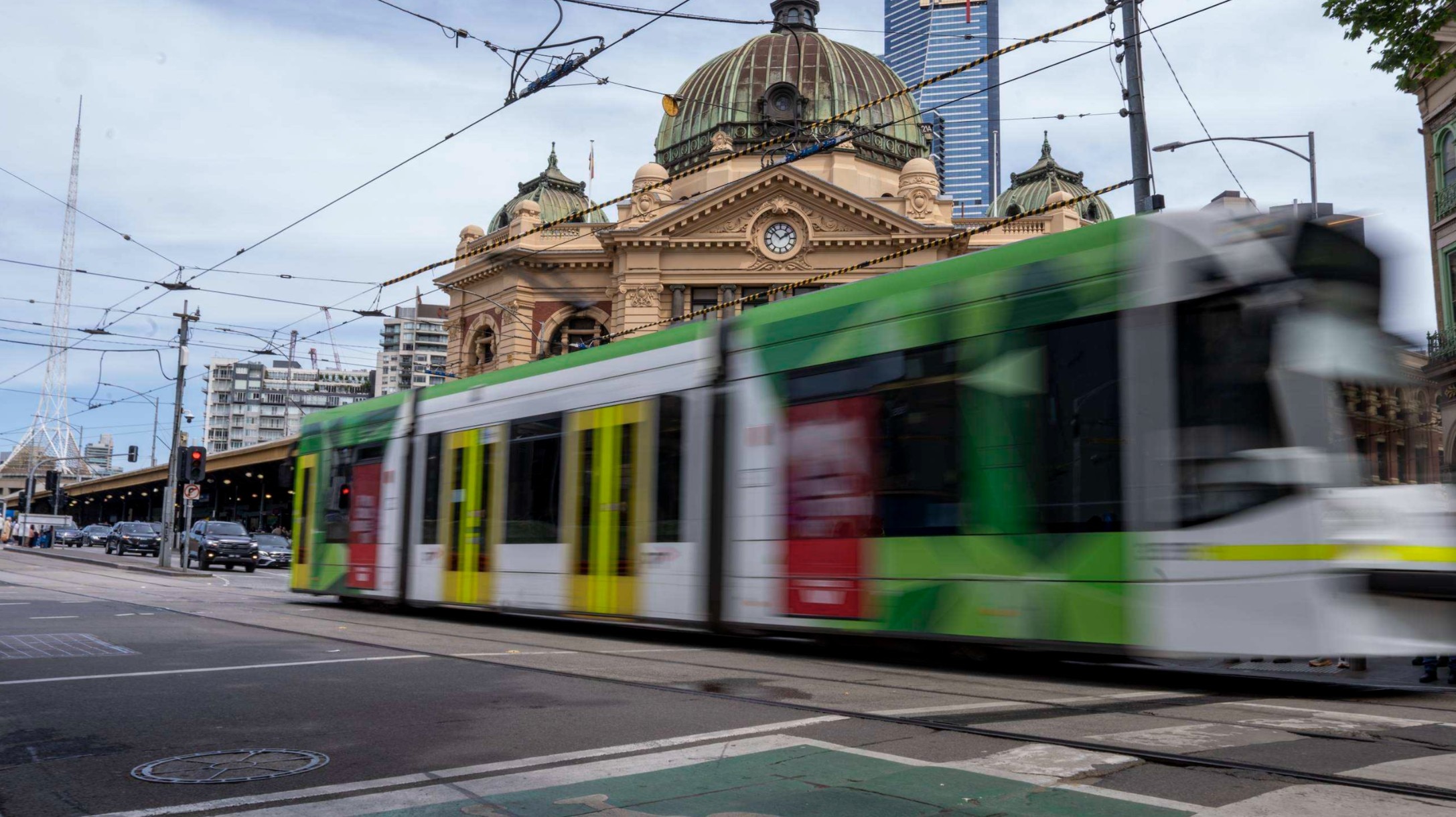 A tram travels past Flinders Street
