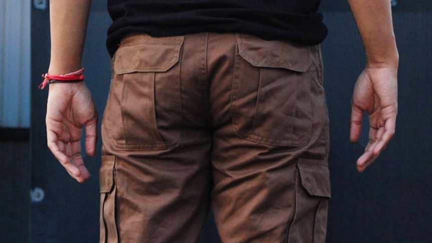 A man wears cargo shorts.