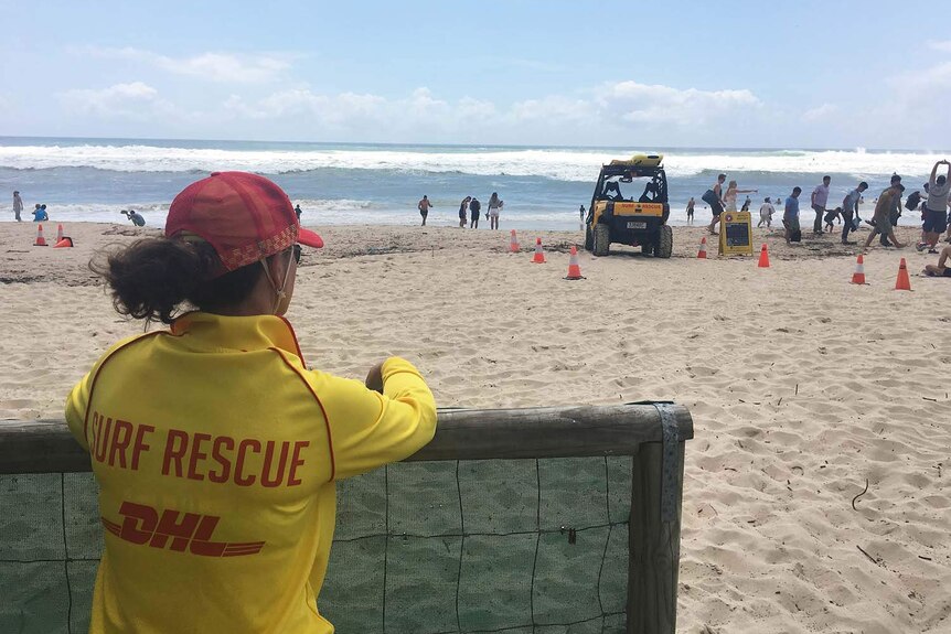 Lifesaver watches wild surf at closed Burleigh Beach on Queensland's Gold Coast on February 18, 2018.