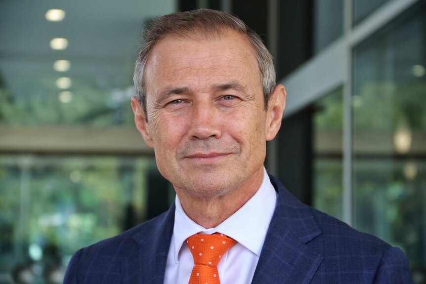 Health minister Roger Cook smiles at the camera.
