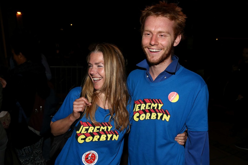 Supporters of Jeremy Corbyn wear blue shirs with "Jeremy Corbyn" emblazoned in red and yellow block text
