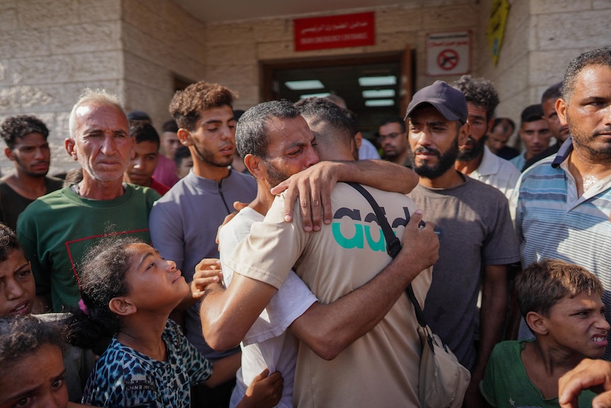 Two prisoners hugging as Prisoners arrive back into gaza.