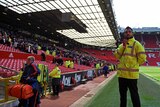 Fans leave the stands at Old Trafford stadium in Manchester.