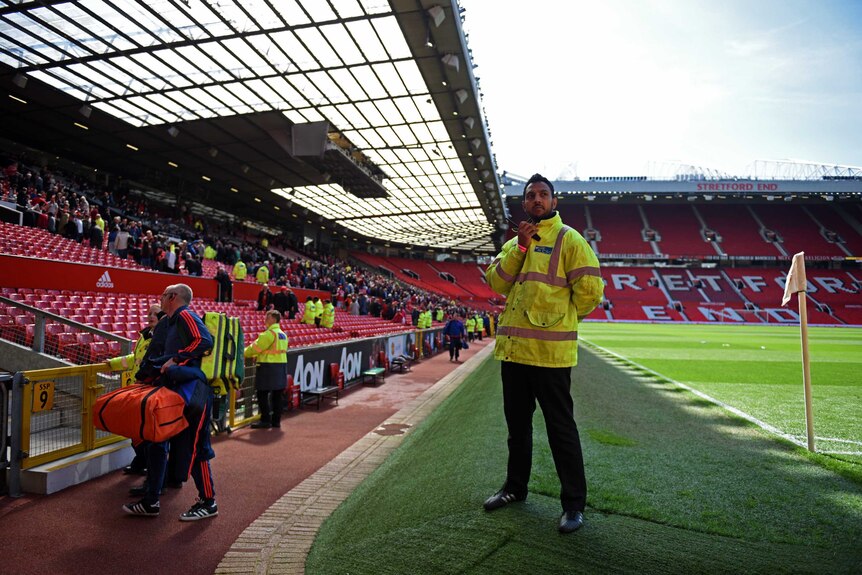 Fans leave the stands at Old Trafford stadium in Manchester.