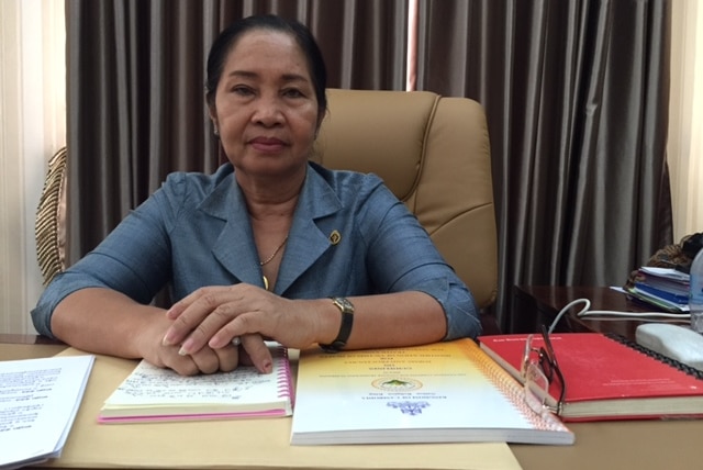 Chou Bun Eng stares at the camera as she sits in her office