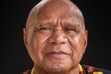 Archie Roach stares into the camera.