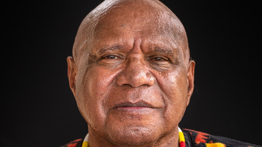 Archie Roach stares into the camera.