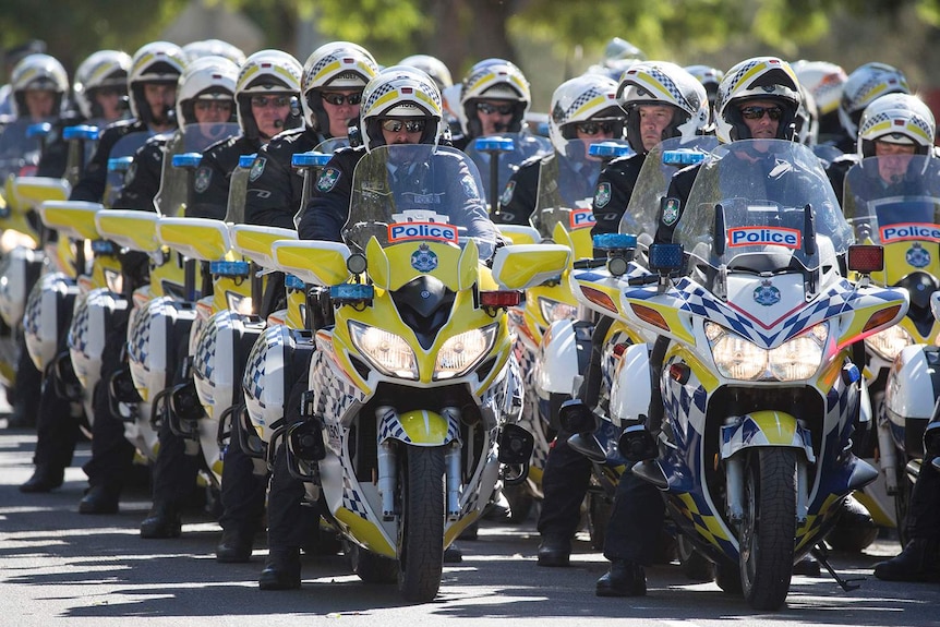 Police motorcycle squad officers ride in a procession