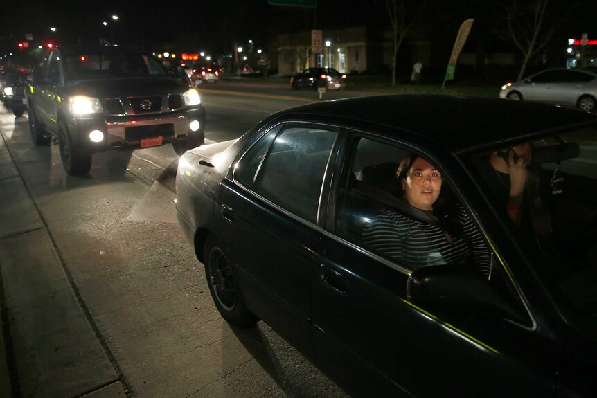 A woman waits in traffic while evacuating from Marysville near the Oroville Dam