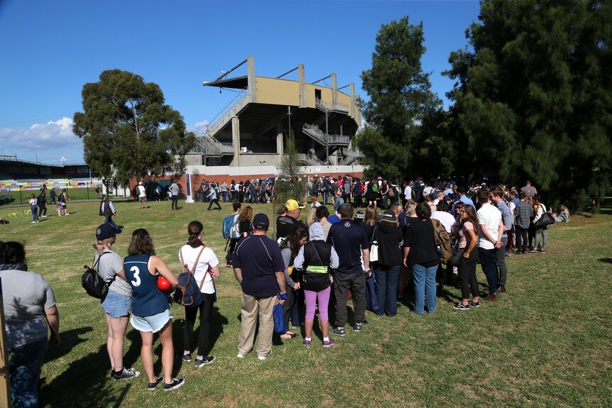 A long queue of spectators lines up to get inside Princes Park for the opening match of the 2018 AFLW season.