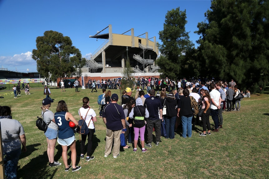 A long queue of spectators lines up to get inside Princes Park for the opening match of the 2018 AFLW season.
