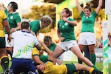 Ireland players celebrate as Sophie Spence scores against Australia at the Women's Rugby World Cup.