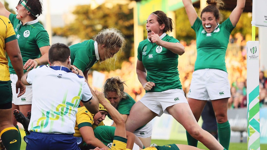 Ireland players celebrate as Sophie Spence scores against Australia at the Women's Rugby World Cup.