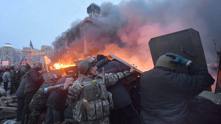 Ukrainian anti-government protester uses a slingshot