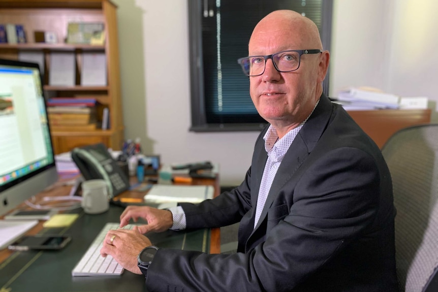 A man sits on front of a computer