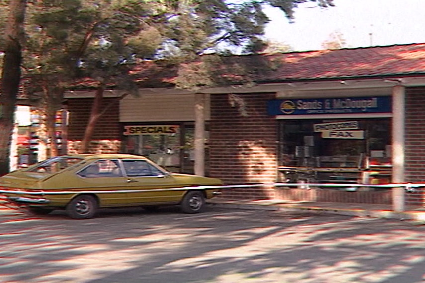 Old TV still of a stationery shop with crime tape in front
