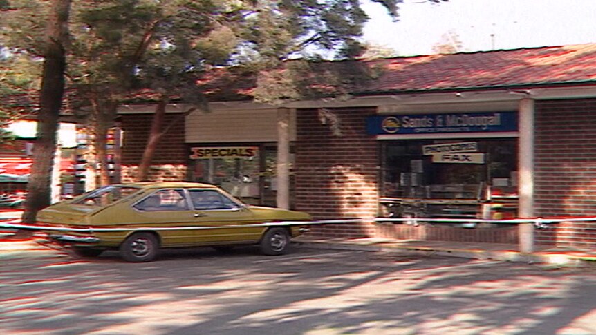 Old TV still of a stationery shop with crime tape in front