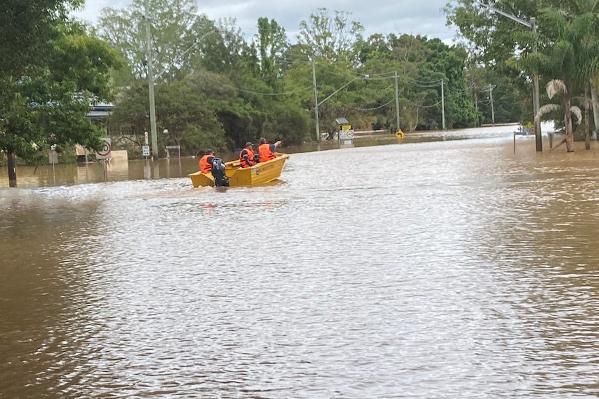 SES crews in a boat in floodwaters.