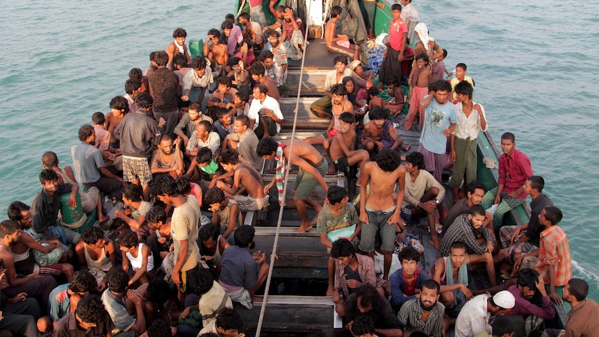 Rohingya migrants sit in a boat off the coast of Indonesia before being rescued on May 20.