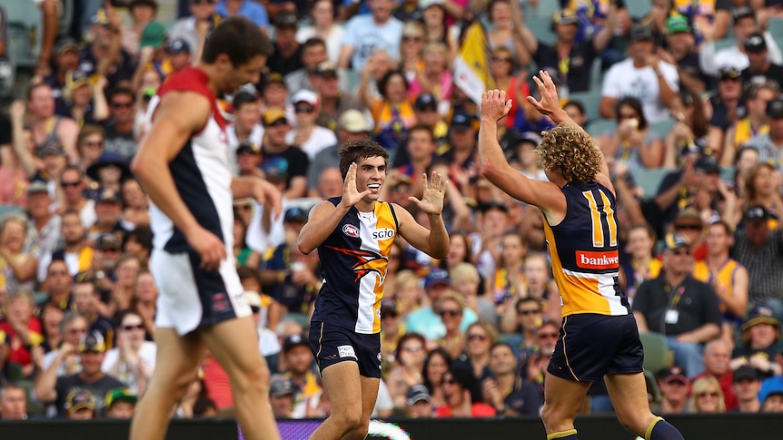 Ecstasy and agony: Andrew Gaff and the Eagles pile on the points against Melbourne.