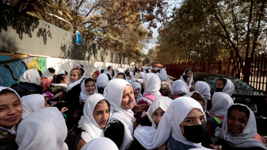 picture of female school students wearing while veil and black uniform