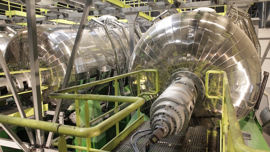 Two silver-coloured industrial cylinders used in recycling