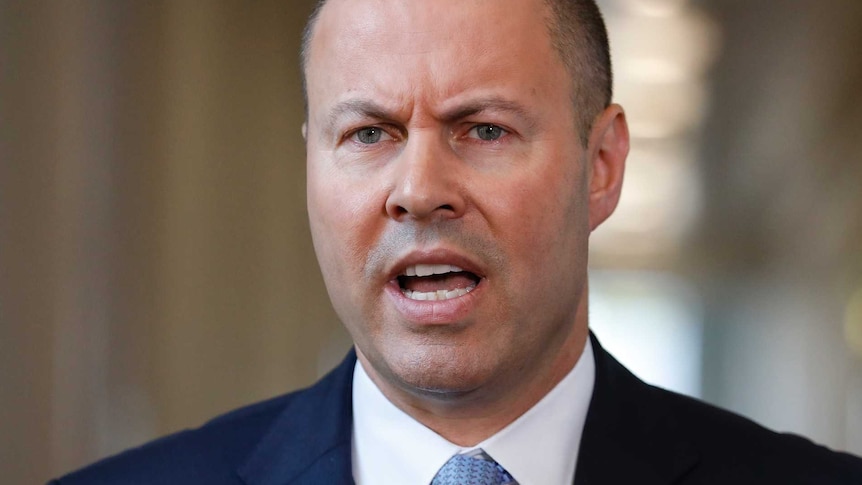 Treasurer Josh Frydenberg wearing a blue tie and a dark blue suit.