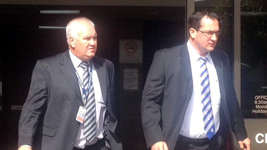 Detective Gareth Reed (right) leaves court