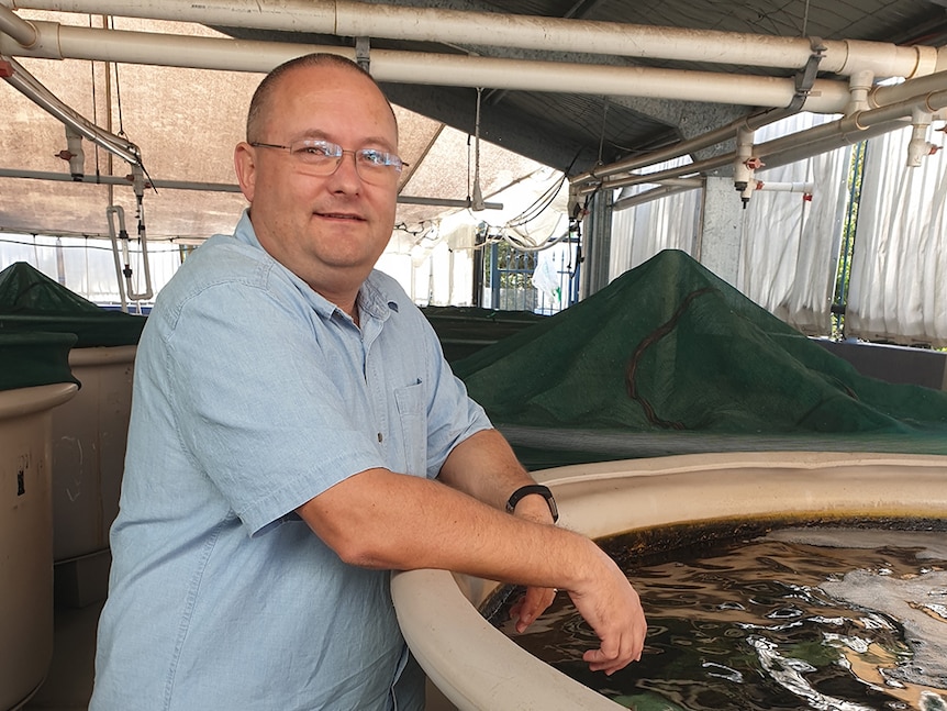 Peter Butcherine next to a tank.