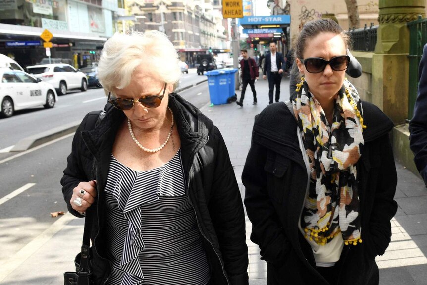 Two women walking.