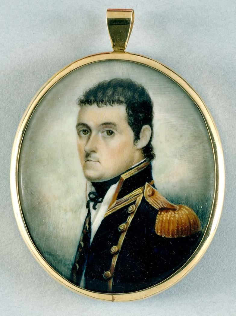 A portrait of a young, dark-haired man in a pea coat with tasseled epaulets.