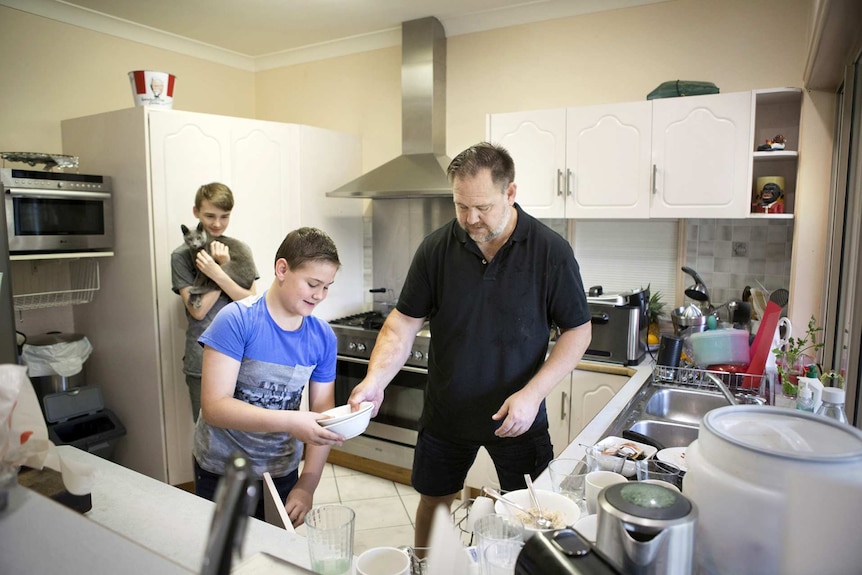 Mark Valencia at home in the kitchen with his two teenage sons