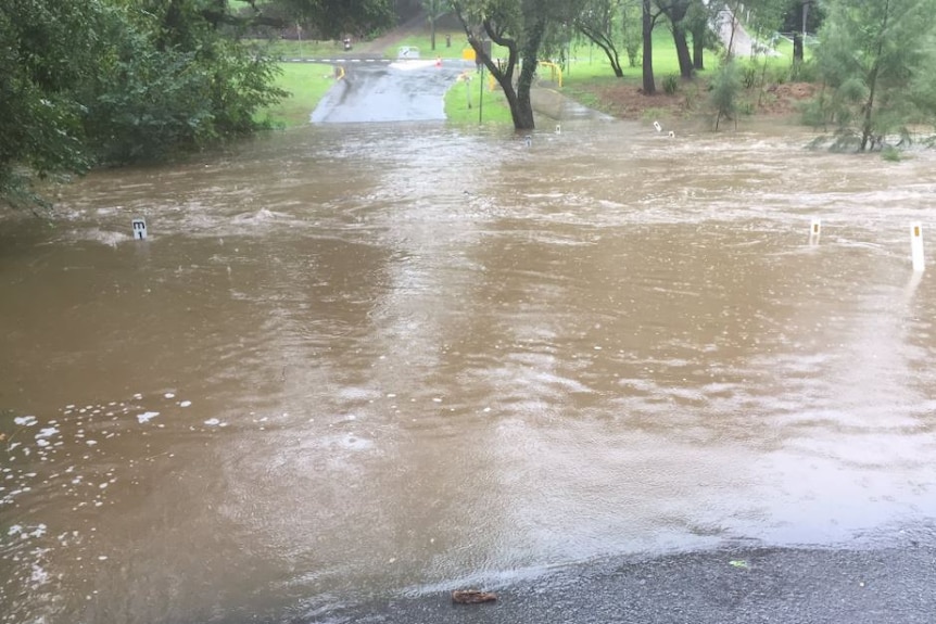 Road flooded near Brookfield state school in Brisbane