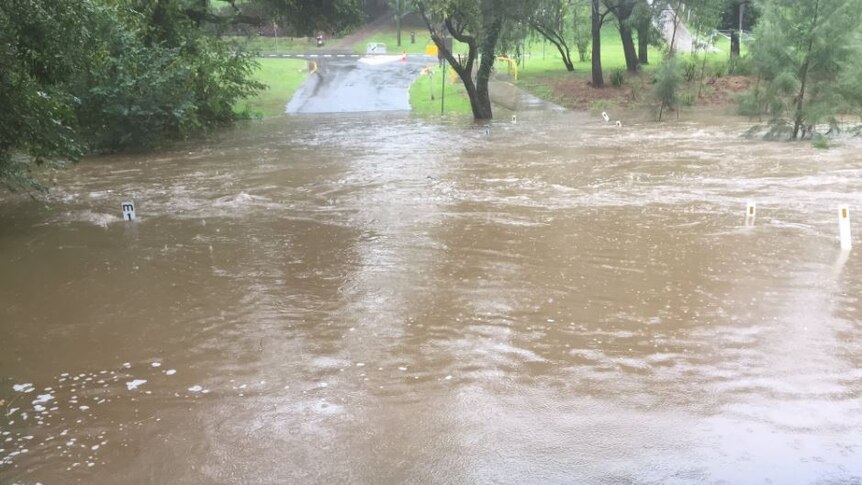 Road flooded near Brookfield state school in Brisbane