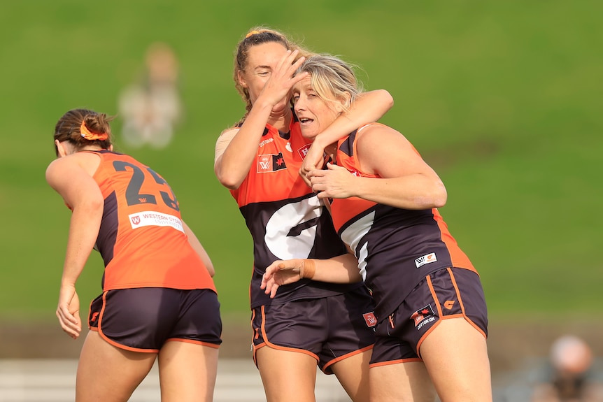 Cora Staunton is hugged by a GWS teammate after kicking a goal
