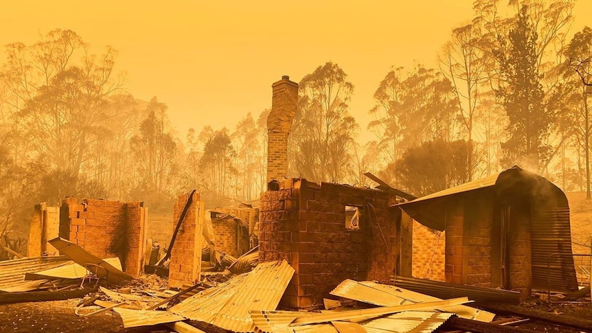 Yellow skies with a burnt our home and chimney, surrounded by trees