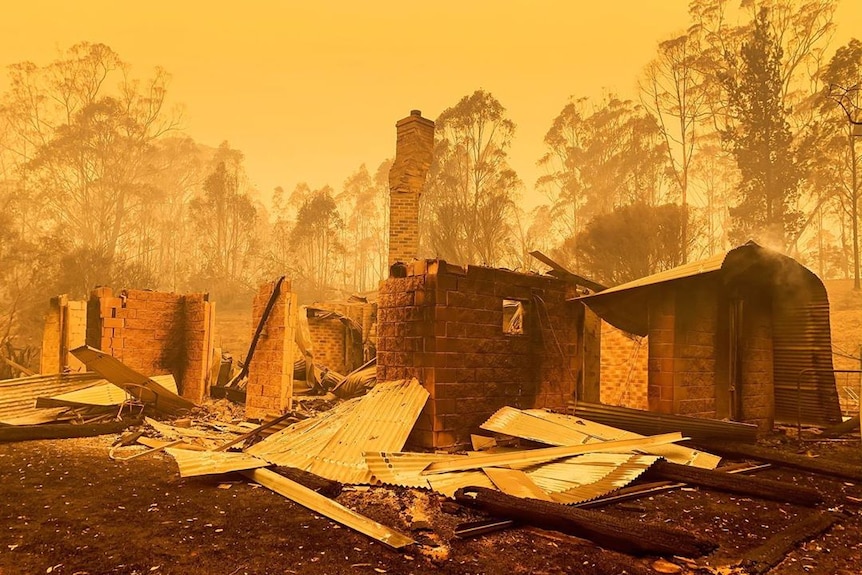 Yellow skies with a burnt our home and chimney, surrounded by trees