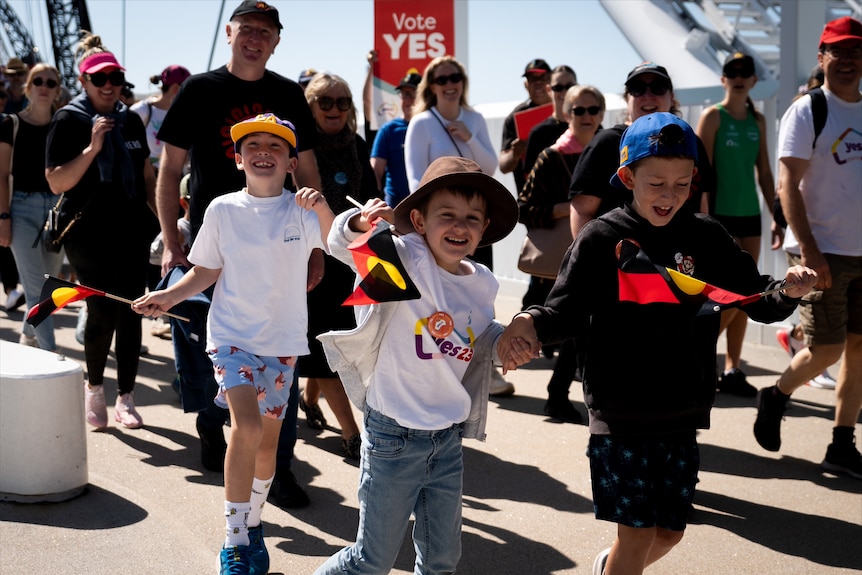 Boys waving Aboriginal flags at Perth rally